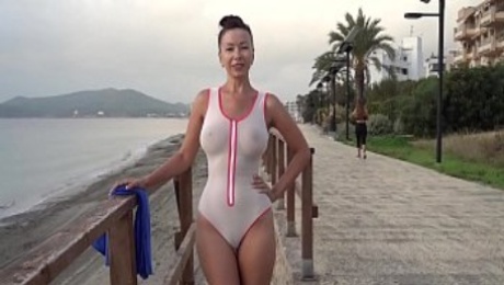 Wet transparent swimsuit in public