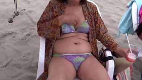 My Latin wife, beautiful 58-year-old mother enjoys the beach, shows off, shows her hairy pussy of hers in a bikini, she masturbates, intense orgasms, cumshot on her delicious body