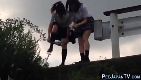 Kinky asians urinating outdoors