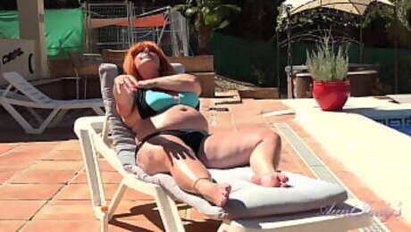 Busty Mature Redhead Melanie gets off by the Pool